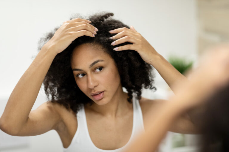Woman receiving PRP hair restoration treatment at Essentia Women’s Health & Aesthetics in Fayetteville, GA.