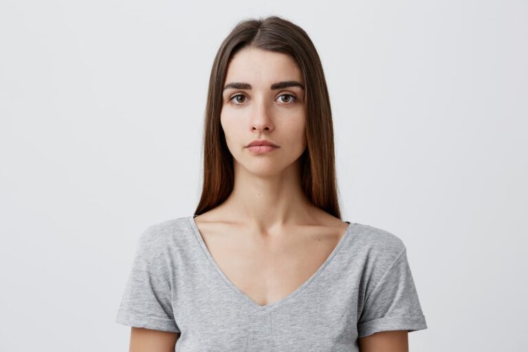 Young woman with thin face showing signs of facial volume loss after weight loss, illustrating Ozempic face