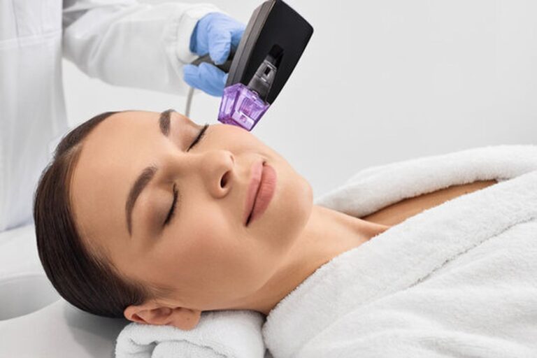 Woman receiving RF microneedling skin tightening treatment at medical spa
