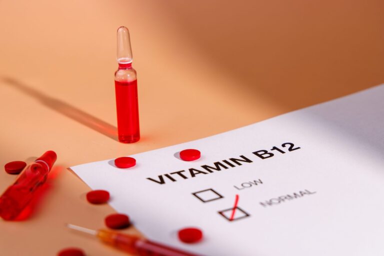Vitamin B12 injection vials, syringe and medical report for weight loss support