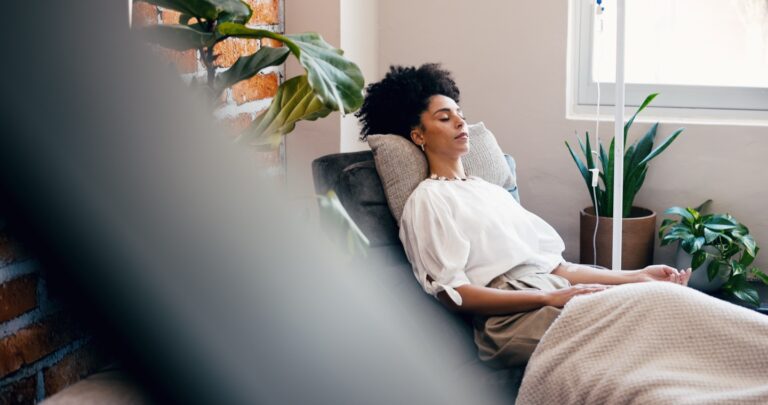 Woman relaxing in a lounge chair during an IV vitamin drip session