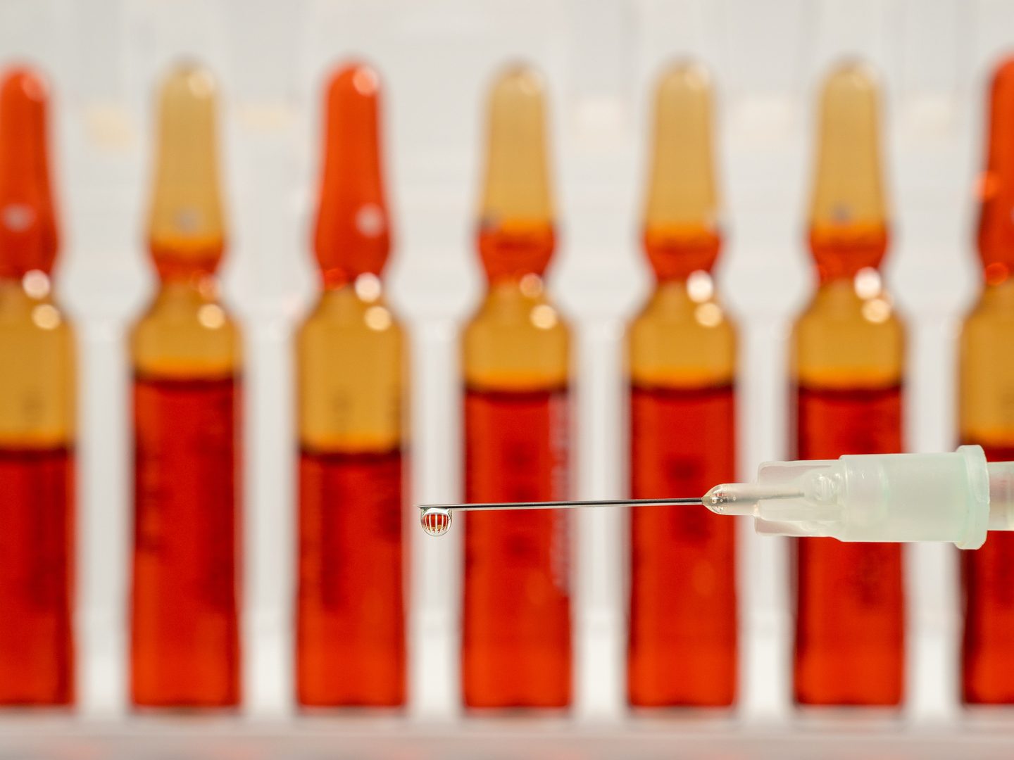 Vitamin B12 injection ampoules and syringe representing treatment cost